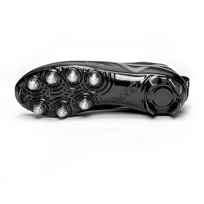 Bottom of Caddix men’s low black/black lacrosse and football cleats, with patented Smart Studs that reduce the torque that causes ACL tears and ankle injuries