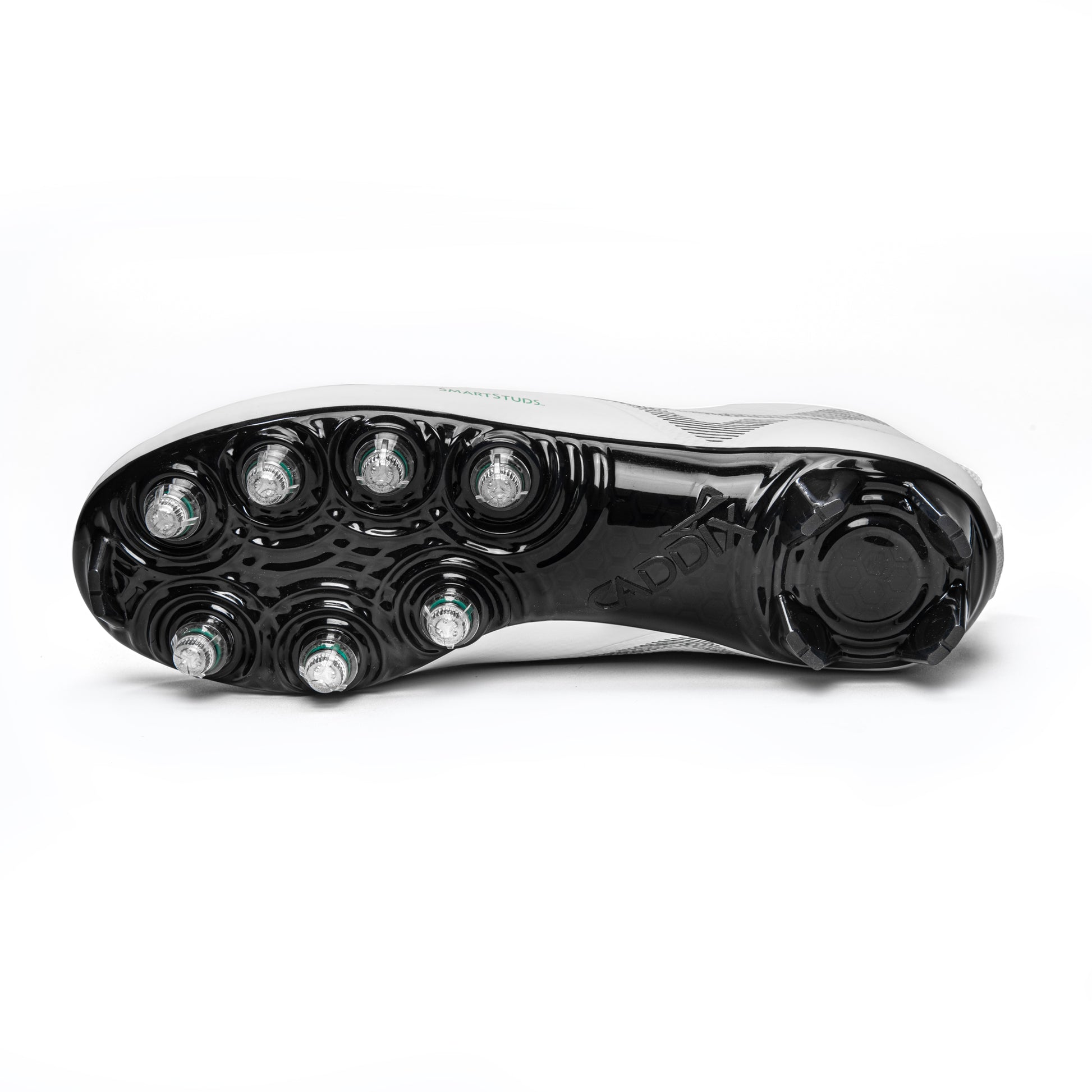 Photo of bottom of white/black Caddix mid men’s football and lacrosse cleats highlighting 7 patented Smart Studs that are proven to reduce ACL tearing torque