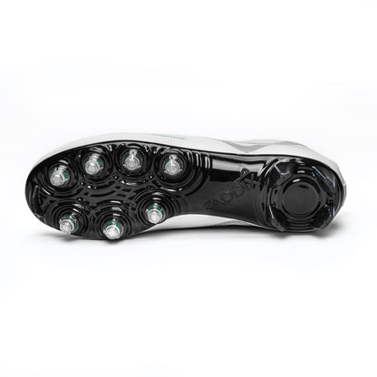 Photo of bottom of white/black Caddix mid men’s football and lacrosse cleats highlighting 7 patented Smart Studs that are proven to reduce ACL tearing torque