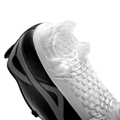 View of bladed heel design on Caddix men’s black/white low football and lacrosse cleats. Patented Smart Studs on forefoot flex to reduce injury-causing torque